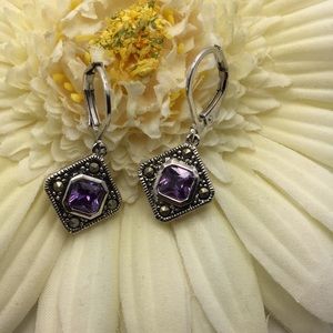 Silver and purple colored earring